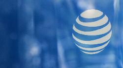 AT&T shares rise modestly in uneven market, outperforming rivals