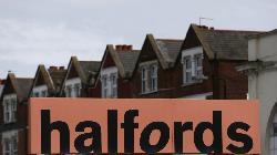 Halfords H1 profit falls 50%, warns of 'softening' sales