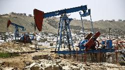 Oil settles lower on weak China data, stronger US dollar