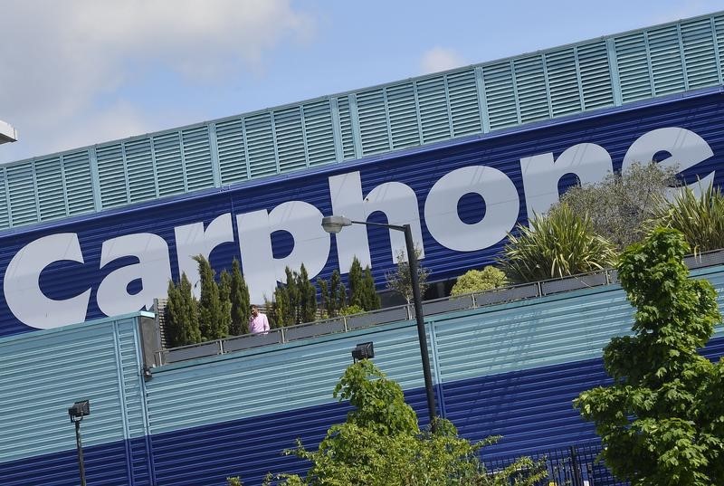 © Reuters. Signs display the logo of Dixons Carphone at the company headquarters in London