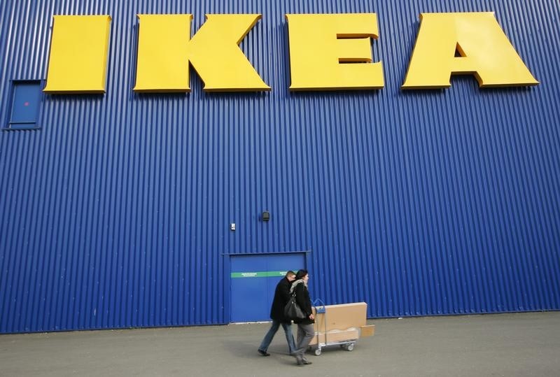 © Reuters. FILE PHOTO: A shopper walks past a sign outside an IKEA store in Wembley, north London