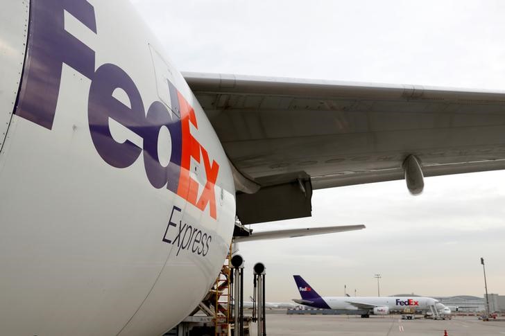 FedEx Tumbles Midday as Company Slashes Forecast; UPS Slightly Down