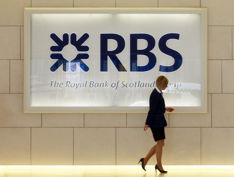 © Reuters. A logo from a Royal Bank of Scotland branch is seen reflected in a window in the City of London