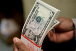 Dollar at 16-month peak as focus turns to retail sales data