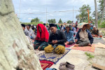 Indonesians pray outdoors after deadly quake destroys town