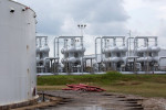 Crude oil prices drop, pressured by stronger U.S. dollar