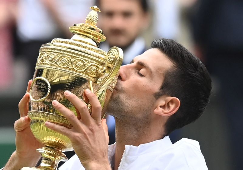 &copy; Reuters. Tennis - Wimbledon - All England Lawn Tennis and Croquet Club, London, Britain - July 11, 2021 Serbia's Novak Djokovic celebrates with the trophy after winning his final match against Italy's Matteo Berrettini REUTERS/Toby Melville