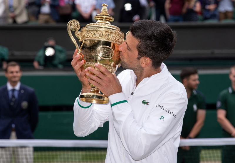&copy; Reuters. Novak Djokovic a rejoint Roger Federer et Rafael Nadal en remportant son 20e titre du Grand Chelem. Le numéro un mondial a soulevé son sixième trophée à Wimbledon en battant Matteo Berrettini 6-7(4) 6-4 6-4 6-3 en 3h27 de jeu. L'Italien a pourtant mo