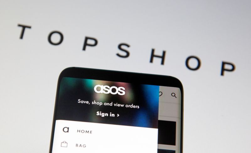 &copy; Reuters. FILE PHOTO: Asos logo is seen in a smartphone in front of a displayed TopShop logo in this illustration taken January 25, 2021. REUTERS/Dado Ruvic/Illustration