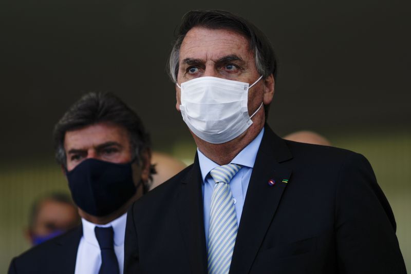 &copy; Reuters. Bolsonaro e Luiz Fux em Brasília
 24/3/2021   REUTERS/Ueslei Marcelino