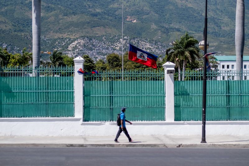 &copy; Reuters. FILE PHOTO: A man walks past in front of where the Haitian Presidential Palace used to be with the Haitian national flag at half-mast, following the assassination of President Jovenel Moise, in Port-au-Prince, Haiti July 10, 2021.  REUTERS/Ricardo Ardueng