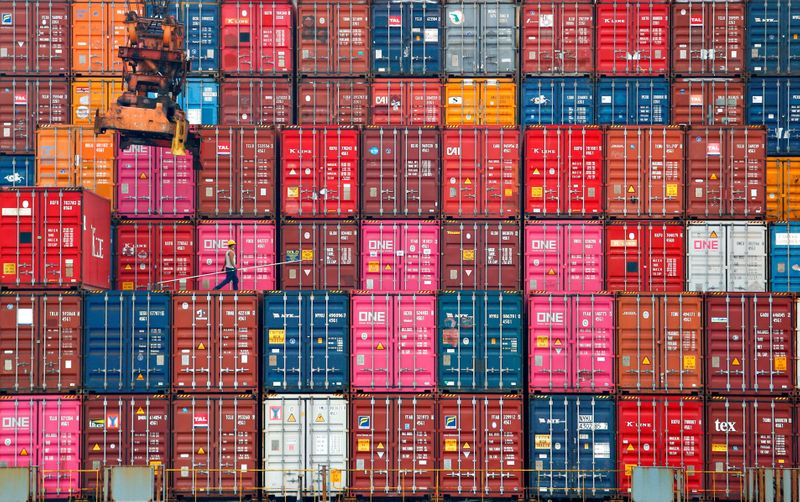 &copy; Reuters. FILE PHOTO: A worker walks on stacks of containers at the Tanjung Priok port in Jakarta, Indonesia, January 22, 2021. REUTERS/Ajeng Dinar Ulfiana