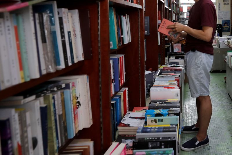 &copy; Reuters. FILE PHOTO: A man reads a book at independent bookstore "Hong Kong Reader", in Hong Kong, China June 23, 2020. REUTERS/Tyrone Siu