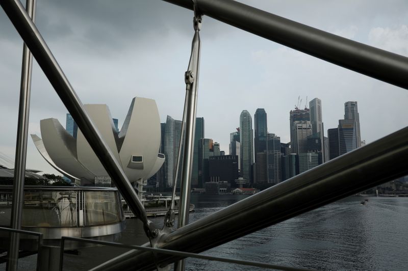 &copy; Reuters. FILE PHOTO: Storm clouds gather over the skyline of the central business district in Singapore April 5, 2021.  REUTERS/Edgar Su