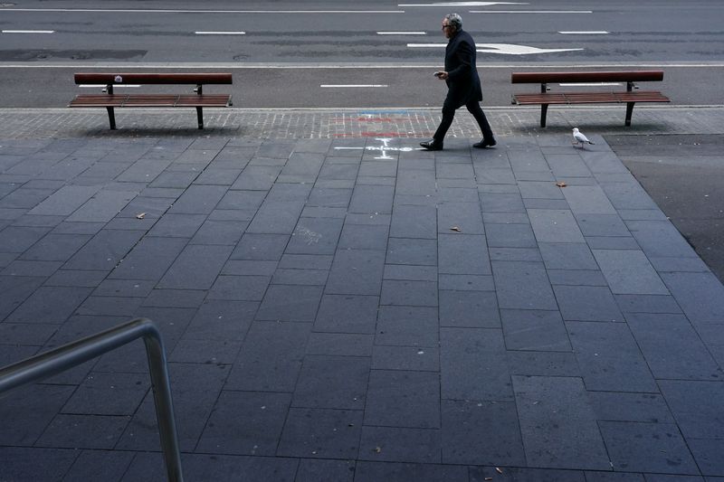 &copy; Reuters. FILE PHOTO: A lone man walks up a deserted street in the city centre during a lockdown to curb the spread of a coronavirus disease (COVID-19) outbreak in Sydney, Australia, July 12, 2021.  REUTERS/Loren Elliott