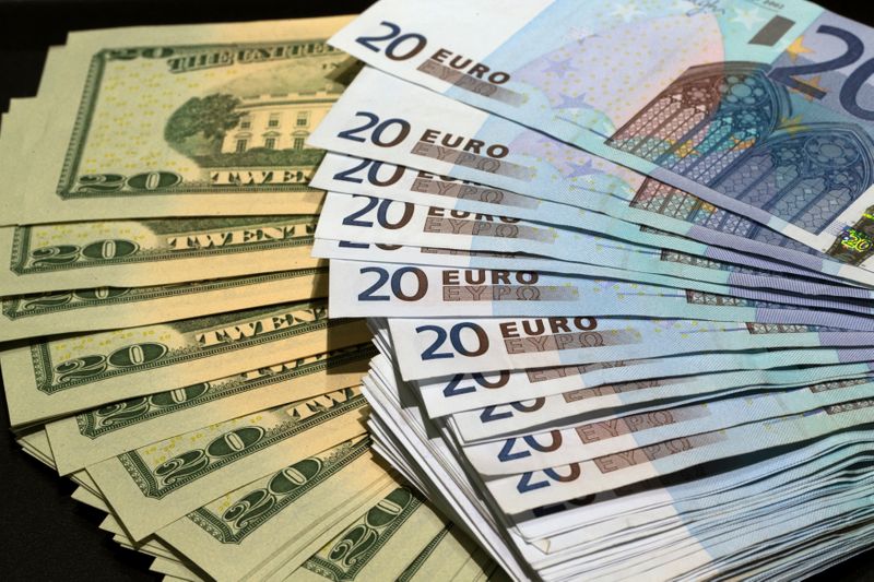 &copy; Reuters. U.S. dollars and euros banknotes are seen in this illustration photo taken at a change bureau in Paris, October 28, 2014. The global economy will gradually improve over the next two years while the euro zone struggles with stagnation and an increased defl