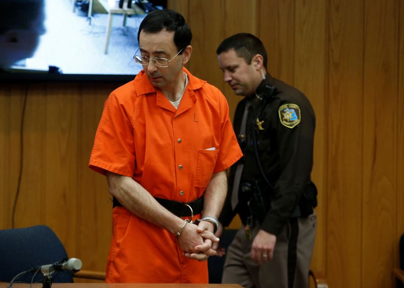 &copy; Reuters. FILE PHOTO: Larry Nassar, a former team USA Gymnastics doctor who pleaded guilty in November 2017 to sexual assault charges, stands in court during his sentencing hearing in the Eaton County Court in Charlotte, Michigan, U.S., February 5, 2018. REUTERS/Re