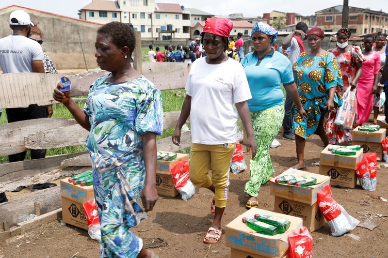 © Reuters. Women queue for food parcels during distribution by volunteers of the Lagos food bank initiative in a community in Oworoshoki, Lagos, Nigeria July 10, 2021. REUTERS/Temilade Adelaja