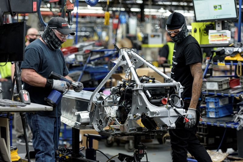 &copy; Reuters. FILE PHOTO: People work on a Polaris snowmobile assembly line at their manufacturing and assembly plant in Roseau, Minnesota, U.S. June 7, 2021.   REUTERS/Dan Koeck