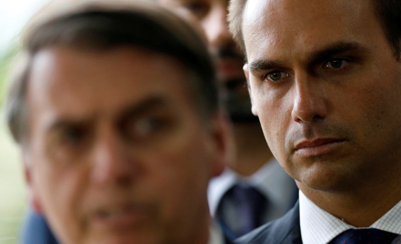 &copy; Reuters. Eduardo Bolsonaro, son of Brazil's President-elect Jair Bolsonaro is seen behind him at the transition government building in Brasilia, Brazil, December 4, 2018. REUTERS/Adriano Machado