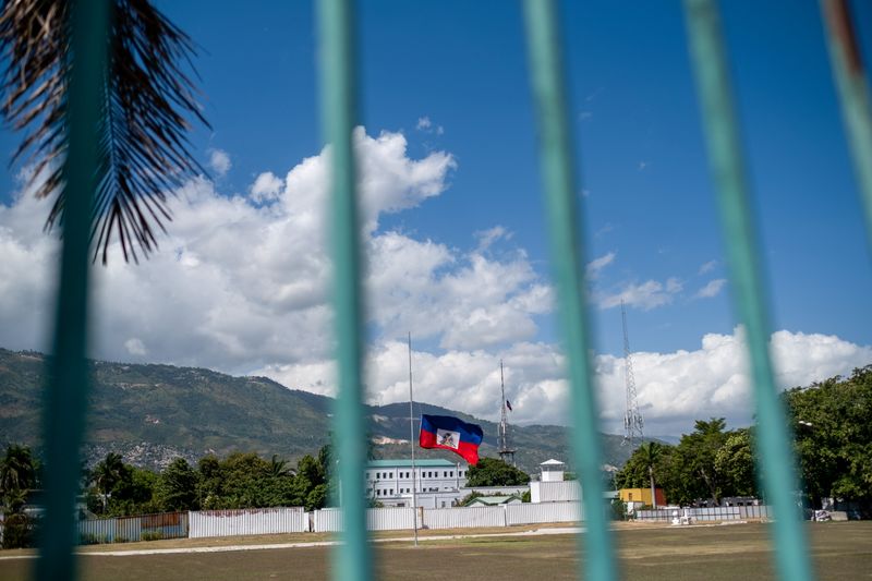 &copy; Reuters. FILE PHOTO: The Haitian national flag waves at half-mast where the Haitian Presidential Palace used to be following the assassination of President Jovenel Moise, in Port-au-Prince, Haiti July 10, 2021. REUTERS/Ricardo Arduengo