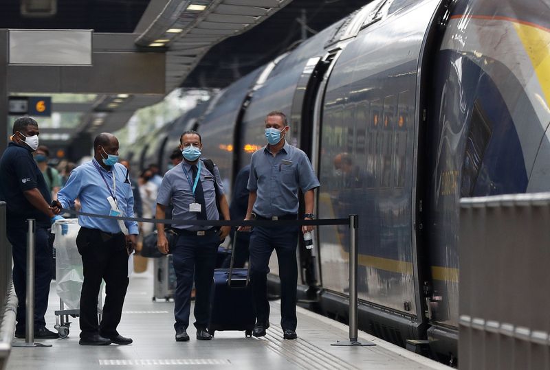 &copy; Reuters. FILE PHOTO: Passengers and staff wearing protective face masks arrive from Paris at Eurostar terminal at St Pancras station, as Britain imposes a 14-day quarantine on arrival from France from Saturday, following the outbreak of the coronavirus disease (CO