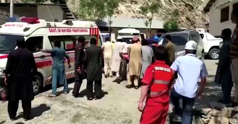 &copy; Reuters. FILE PHOTO: People wheel a gurney towards an ambulance outside a hospital in Dasu, after a bus with Chinese nationals on board plunged into a ravine in Upper Kohistan following a blast, Pakistan July 14, 2021 in this still image taken from video.  REUTERS