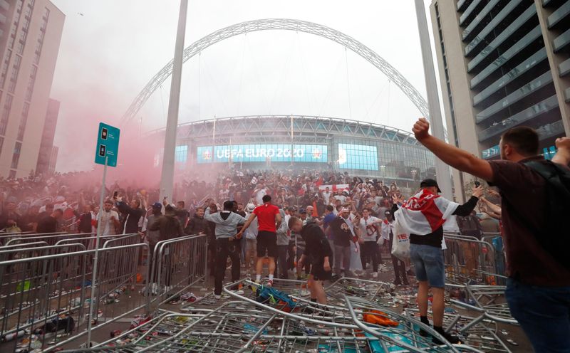 &copy; Reuters. FILE PHOTO: Soccer Football - Euro 2020 - Final - Fans gather for Italy v England - Wembley Stadium, London, Britain - July 11, 2021 Picture taken July 11, 2021 England fans celebrate outside Wembley Stadium during the match Action Images via Reuters/Lee 