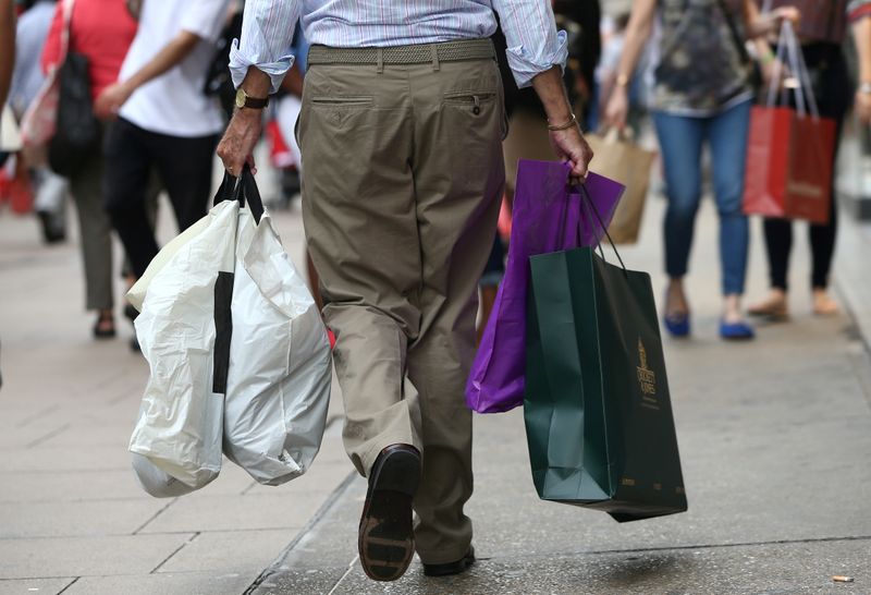 &copy; Reuters. FILE PHOTO: Shoppers carry bags in London, Britain August 25, 2016. REUTERS/Neil Hall/File Photo