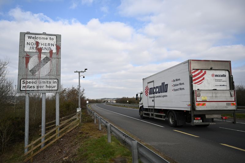 &copy; Reuters. A truck drives past a defaced 'Welcome to Northern Ireland' sign on the Ireland and Northern Ireland border reminding motorists that the speed limits will change from kilometres per hour to miles per hour on the border in Carrickcarnan, Ireland, March 6, 