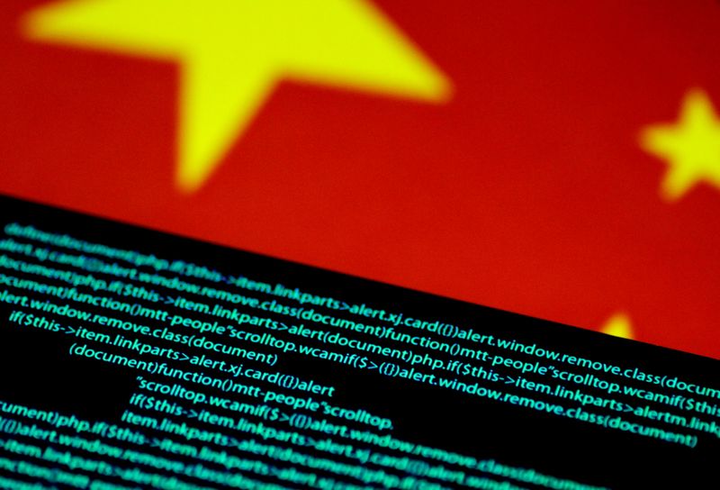 &copy; Reuters. Bandiera cinese raffigurata sopra ad un codice computer. 12 luglio 2017.   REUTERS/Thomas White/Illustration/File Photo/File Photo