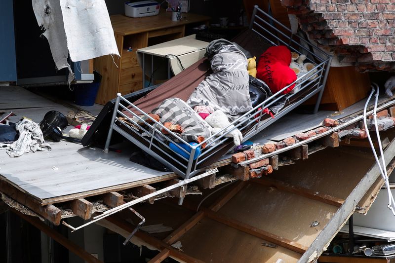 &copy; Reuters. FILE PHOTO: A view of a bed and personal stuff inside a destroyed building at an area affected by floods, following heavy rainfalls, in Pepinster, Belgium, July 17, 2021. REUTERS/Yves Herman