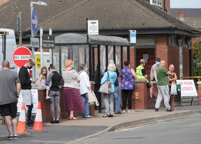 &copy; Reuters. FILE PHOTO: People wait in line at a testing centre near the Crown and Anchor pub following a spike in cases of the coronavirus disease (COVID-19) to visitors of the pub in Stone, Britain, July 30, 2020. REUTERS/Carl Recine