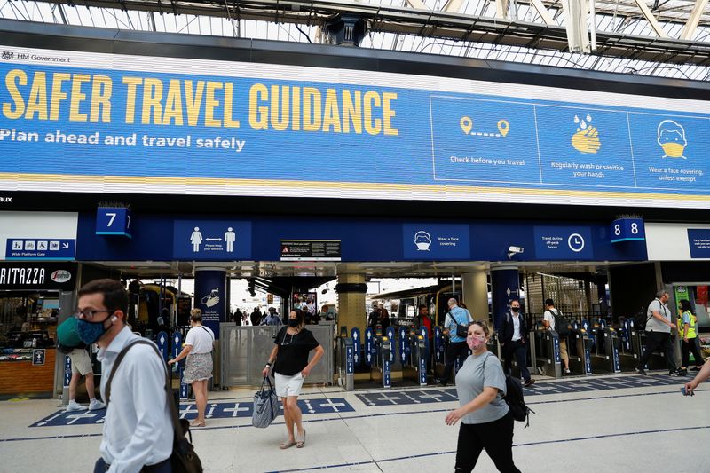 &copy; Reuters. Commuters walk past a travel guidance sign, amid the coronavirus disease (COVID-19) pandemic, in Waterloo station, London, Britain, July 19, 2021. REUTERS/Peter Nicholls/Files