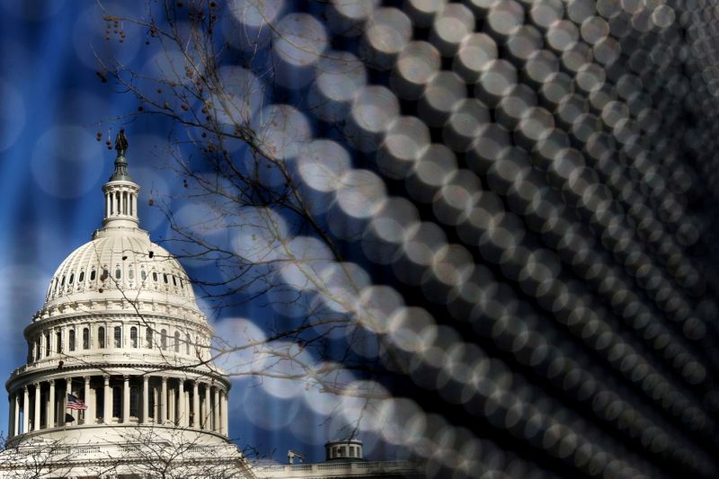 &copy; Reuters. FILE PHOTO: Light catches the security fence around the U.S. Capitol, erected in the wake of the January 6th attack but now scheduled to start being removed, in Washington, U.S. March 15, 2021.  REUTERS/Jonathan Ernst/File Photo