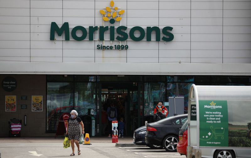 &copy; Reuters. A customer carries a shopping bag outside a Morrisons supermarket in New Brighton, Britain, July 5, 2021. REUTERS/Phil Noble