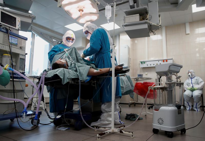 &copy; Reuters. Doctor Islam Muradov (R) performs emergency surgery in the operating room of the City Clinical Hospital Number 15 named after O. Filatov, which delivers treatment to patients infected with the coronavirus disease (COVID-19), in Moscow, Russia May 25, 2020