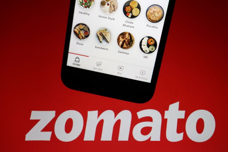 &copy; Reuters. FILE PHOTO: The app of Indian food delivery company Zomato is seen on a mobile phone above its logo displayed in this illustration picture taken July 14, 2021. REUTERS/Florence Lo/Illustration