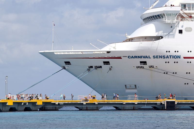&copy; Reuters. FILE PHOTO: Passengers of the Carnival Sensation, operated by Carnival Cruise Line, are seen next to the docked cruise ship in Cozumel, Mexico June 6, 2019. REUTERS/Jorge Delgado