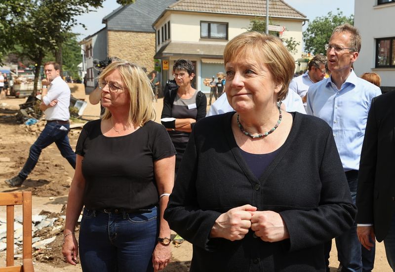 &copy; Reuters. المستشارة الألمانية أنجيلا ميركل تزور منطقة تأثرت بالفيضانات في ألمانيا يوم الثلاثاء. تصوير: فولفجانج راتاي - رويترز.