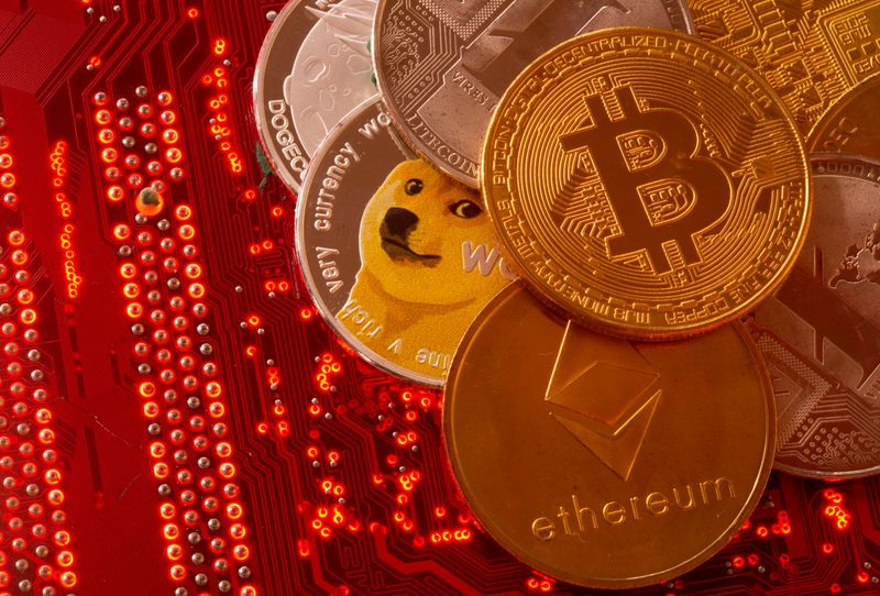 &copy; Reuters. Representations of cryptocurrencies Bitcoin, Ethereum, DogeCoin, Ripple, Litecoin are placed on PC motherboard in this illustration taken, June 29, 2021. REUTERS/Dado Ruvic/Illustration