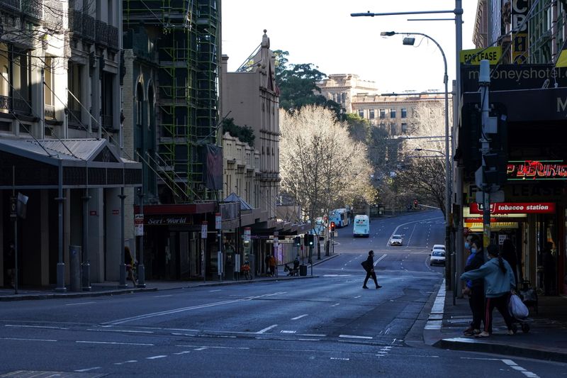 &copy; Reuters. A pedestrian crosses an almost empty street in the City Centre during a lockdown to curb the spread of the coronavirus disease (COVID-19) outbreak in Sydney, Australia, July 21, 2021. REUTERS/Loren Elliott