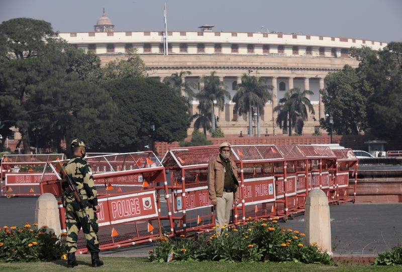 &copy; Reuters. FILE PHOTO: Security personnel stand guard next to barricades outside the Parliament where annual budget is being presented in New Delhi, India, February 1, 2021. REUTERS/Anushree Fadnavis