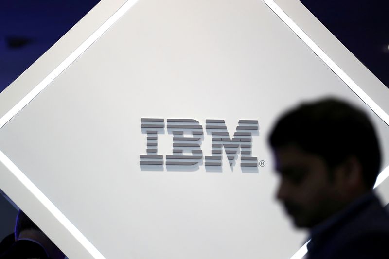 © Reuters. FILE PHOTO: A man stands near an IBM logo at the Mobile World Congress in Barcelona, Spain, February 25, 2019. REUTERS/Sergio Perez//File Photo