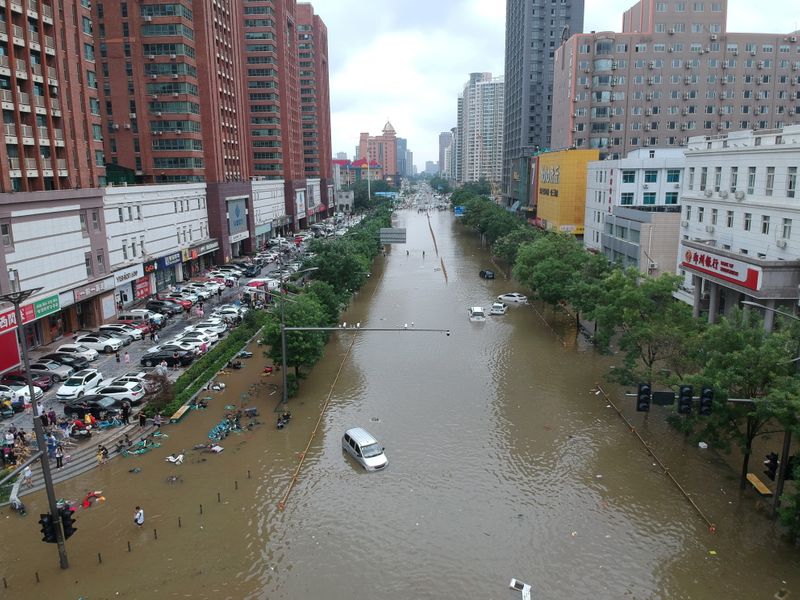 &copy; Reuters. FILE PHOTO: An aerial view shows a flooded road section following heavy rainfall in Zhengzhou, Henan province, July 21. China Daily via REUTERS/File Photo
