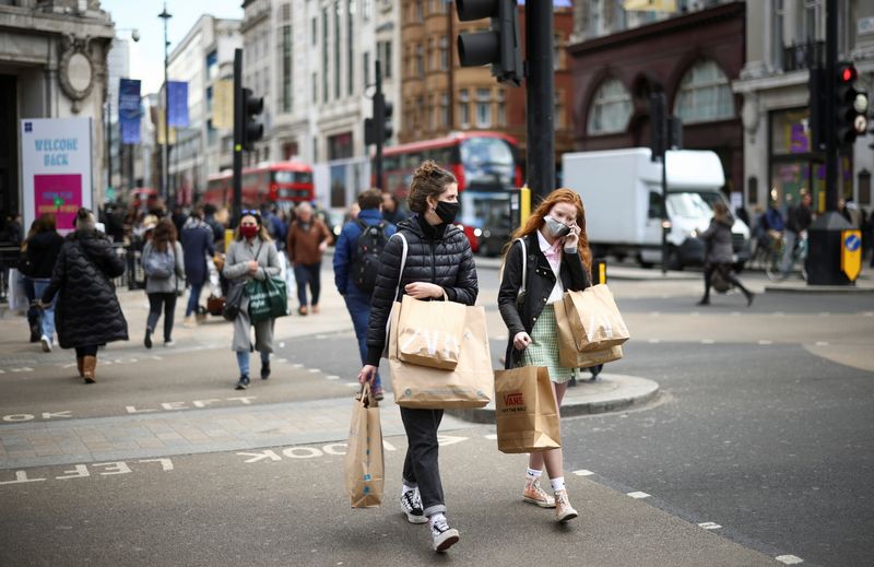 &copy; Reuters. FILE PHOTO:  People walk at Oxford Street, as the coronavirus disease (COVID-19) restrictions ease, in London, Britain April 12, 2021. REUTERS/Henry Nicholls/File photo