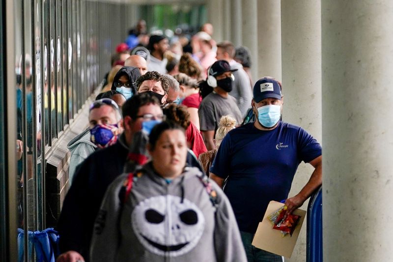 &copy; Reuters. Pessoas fazem fila em centro de carreiras de Kentucky, nos EUA, em busca de assistência com pedidos de auxílio-desemprego. June 18, 2020. REUTERS/Bryan Woolston/File Photo