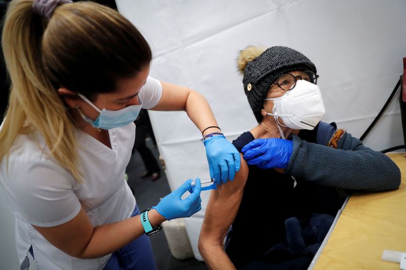 © Reuters. FILE PHOTO: A healthcare worker administers a shot of the Moderna COVID-19 Vaccine to a woman at a pop-up vaccination site operated by SOMOS Community Care during the coronavirus disease (COVID-19) pandemic in Manhattan in New York City, New York, U.S., January 29, 2021. REUTERS/Mike Segar