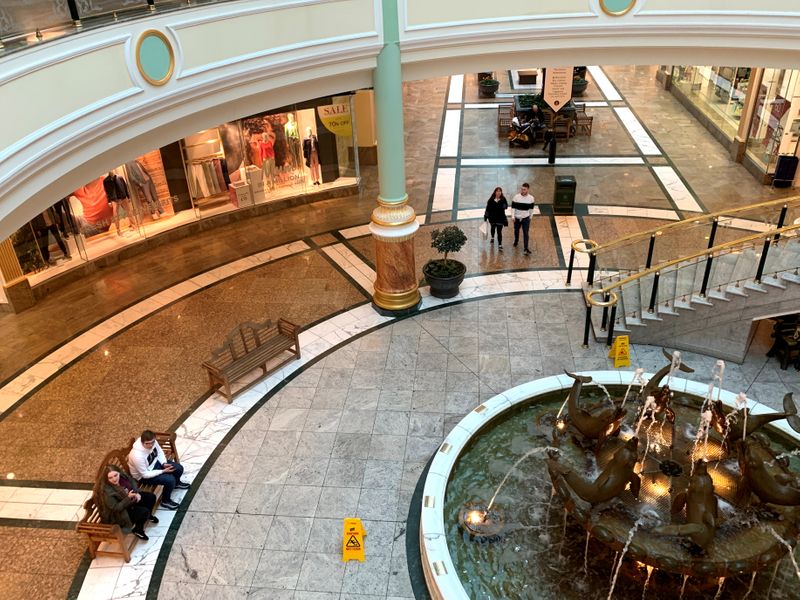 &copy; Reuters. FILE PHOTO: Shoppers are seen inside a near deserted Intu Trafford Centre amid the coronavirus outbreak in Manchester, Britain, March 18, 2020. REUTERS/Phil Noble