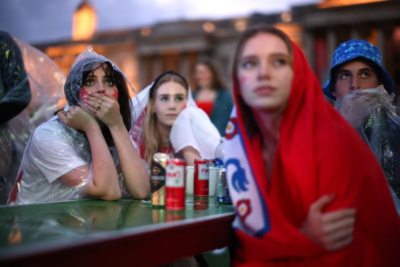 &copy; Reuters. FILE PHOTO:  Soccer Football - Euro 2020 - Final - Fans gather for Italy v England - London, Britain - July 11, 2021 England fans react while watching the match at Trafalgar Square REUTERS/Henry Nicholls/File photo